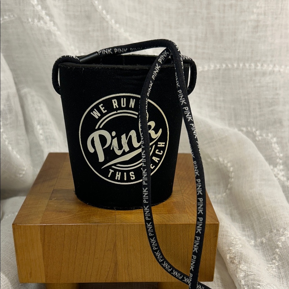 Pink Victoria’s Secret koozie with a strap